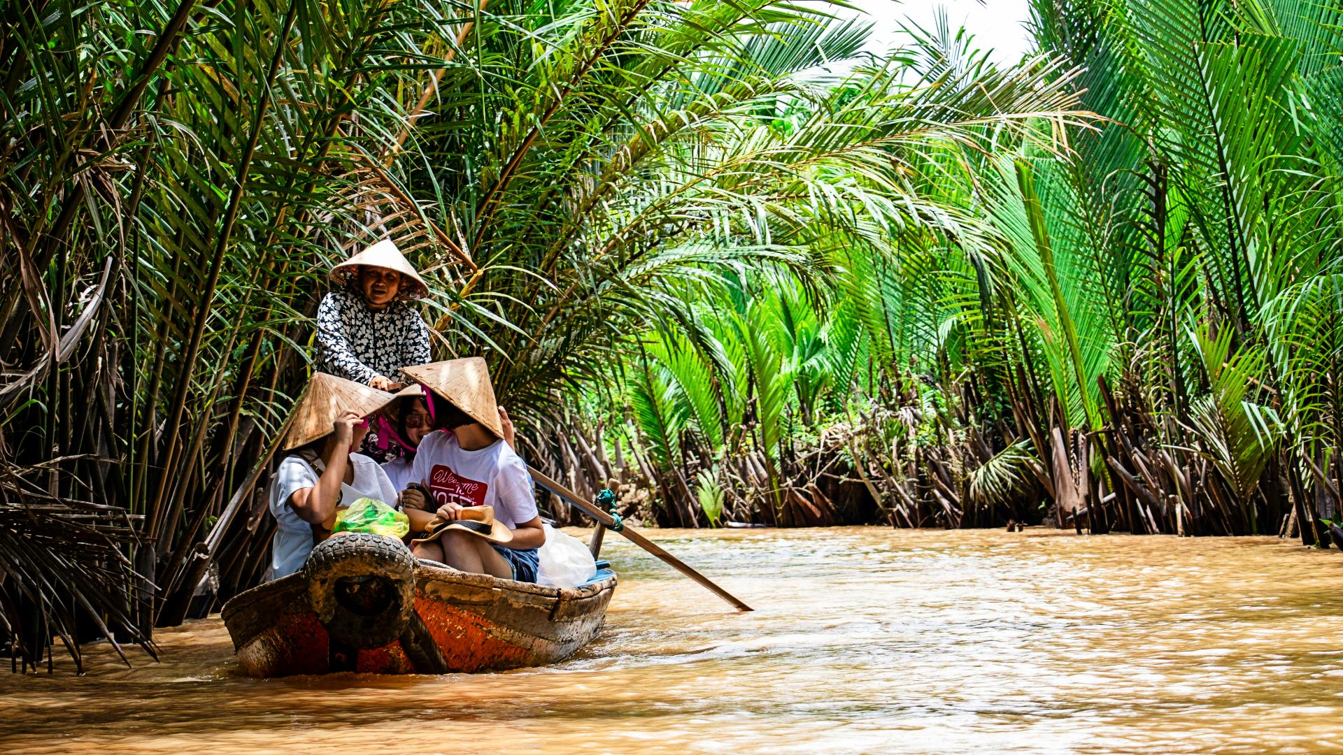 turistas-navegando-delta-mekong Turistas navegando por los canales del río Mekong en Vietnam